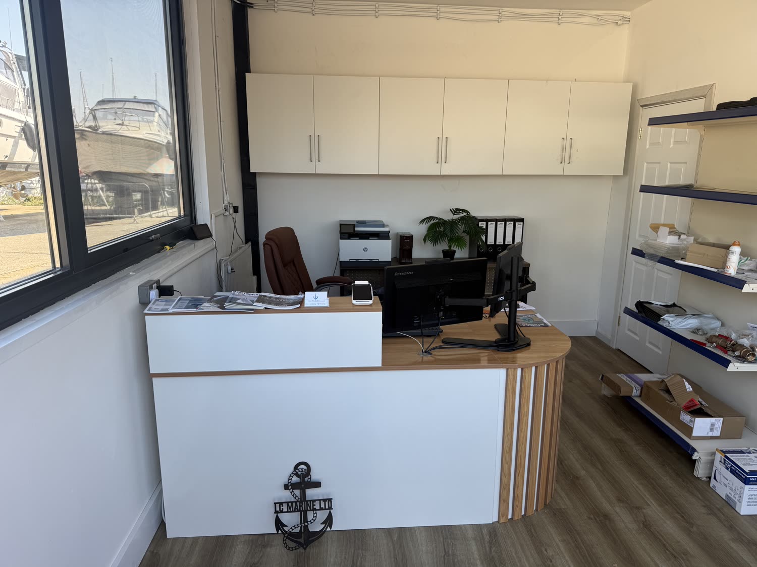 LC Marine reception office at Birdham Pool Marina, boats visible through the window